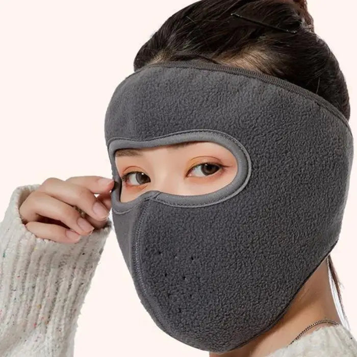 Gray fleece face mask for women providing warmth and comfort in winter outdoor conditions.