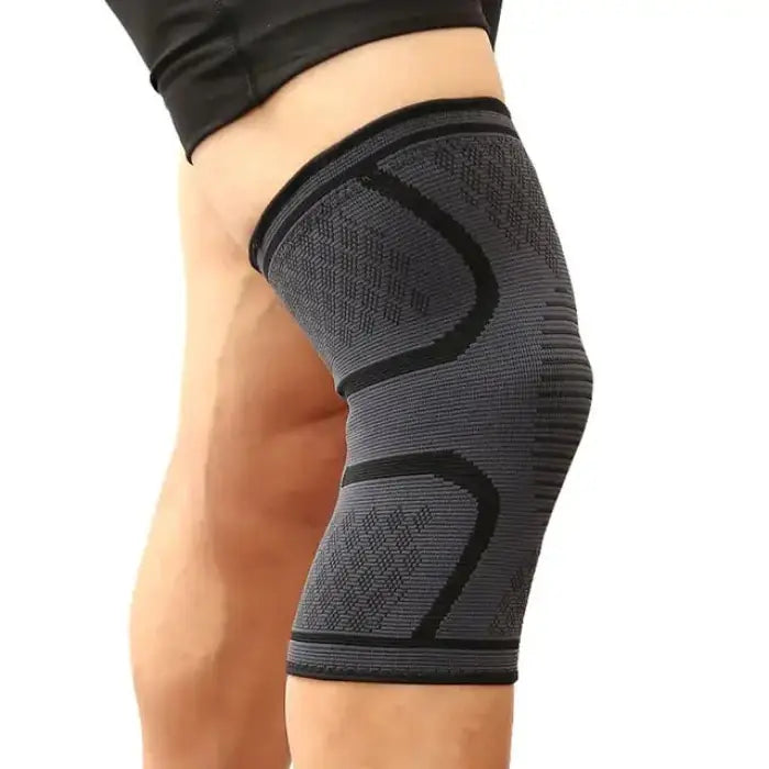 Close-up of gray knee support sleeve with black geometric pattern, worn on leg demonstrating fit and texture