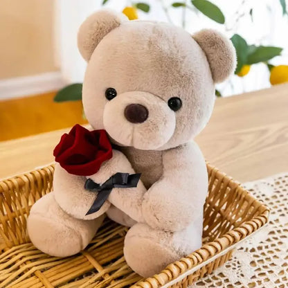 Adorable gray teddy bear in a wicker basket with a red rose and bow.