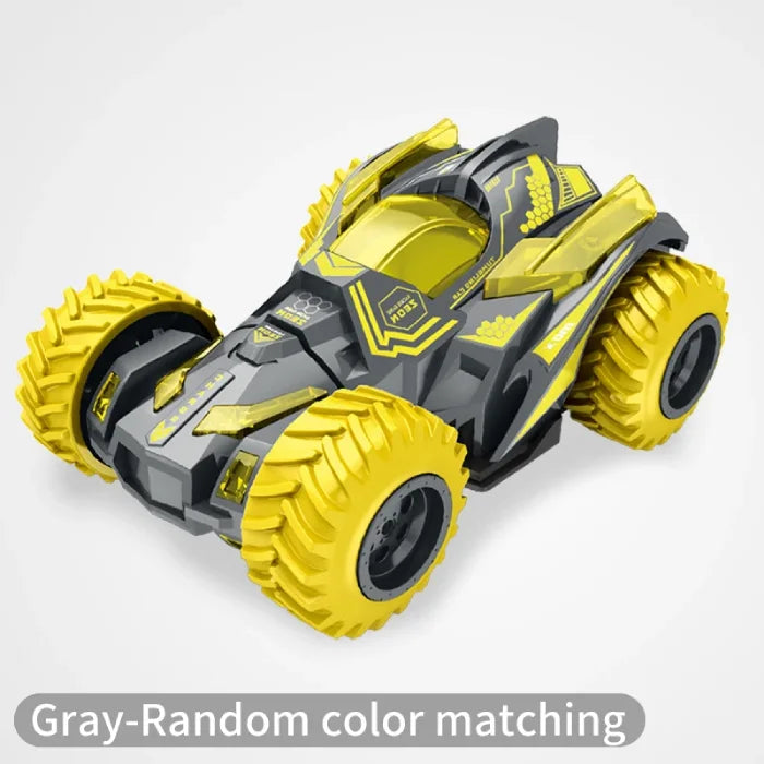 Gray and yellow stunt car with large rugged tires and a durable design on a white background.