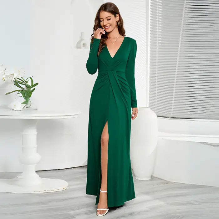 Green long sleeve V-neck maxi dress with a front slit and ruched waist detail.