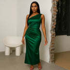 green satin one-shoulder prom gown with a sleek ruched front design, styled with pink heels in a minimalist setting.