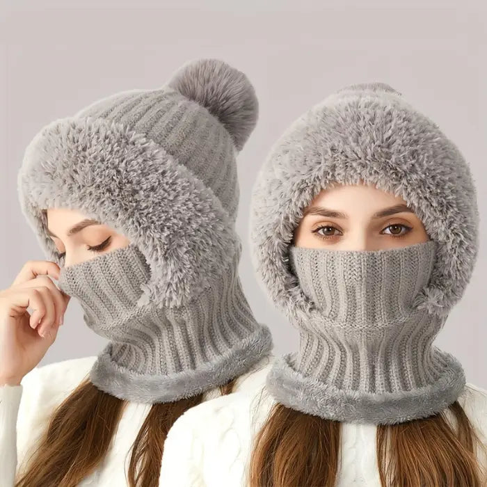 Person wearing a grey and white fuzzy knit winter hat with a face covering that only shows their eyes 