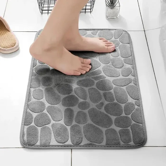 Comfortable grey bathroom mat with textured design for slip resistance.