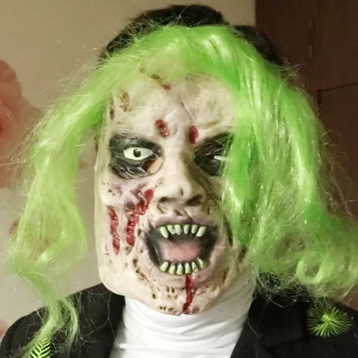 Gruesome costume mask with neon green hair, rotting skin, and bloody mouth.