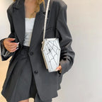 Halloween Coffin-shape Shoulder Bag in white with black spiderweb design, styled with oversized black blazer