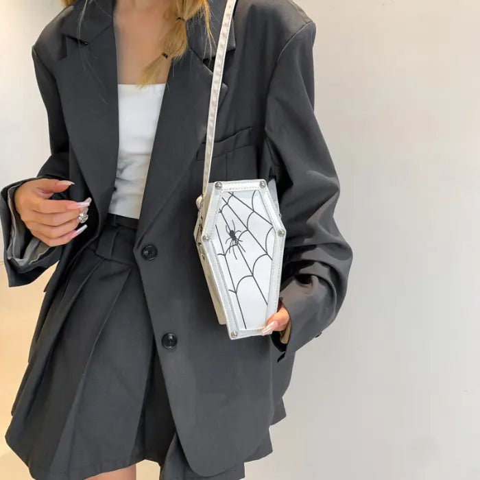 Halloween Coffin-shape Shoulder Bag in white with black spiderweb design, styled with oversized black blazer