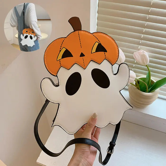 Halloween crossbody bag shaped like a ghost with pumpkin top, shown in close-up by a window.