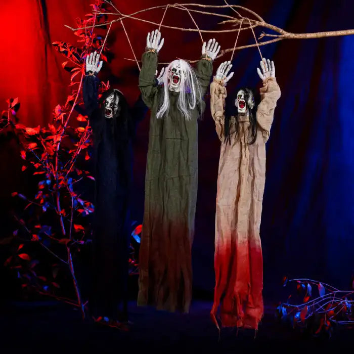 Halloween Decor Hanging Ghoul trio with raised arms, creepy faces, and tattered robes in eerie lighting.