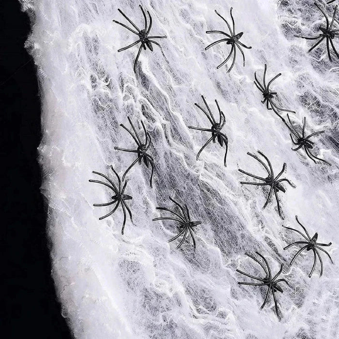 Halloween decoration set showing white spider web fabric decorated with several black plastic spiders