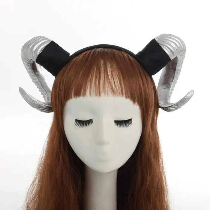 Halloween Devil Horns headband in metallic silver worn by mannequin with long brown wig, front view.