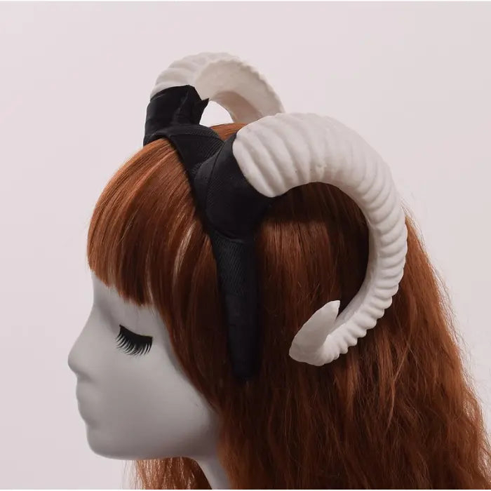 Halloween Devil Horns headband in white color shown on mannequin from side angle with curly horn style.