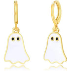 Glossy white ghost Halloween earrings with gold trim and black eyes on reflective surface.