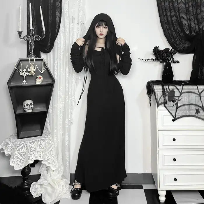 Halloween Elvira outfit gothic hooded black dress with long sleeves styled in spooky indoor setting