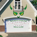 Halloween garage decor with a green dragon face and sharp teeth displayed on a white garage door