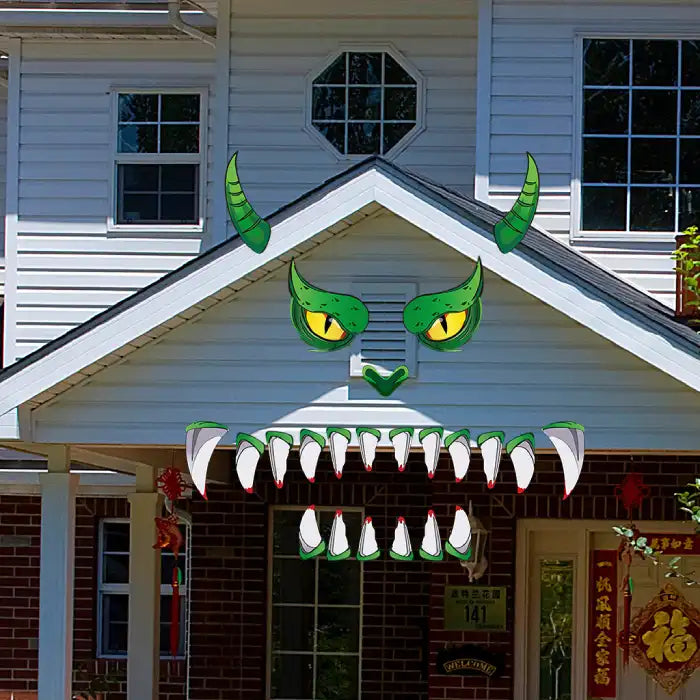 Halloween garage decor with a dragon face decal applied above a house entrance with brick and siding