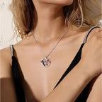 Halloween Gothic necklace with Jack and Sally heart pendant worn by woman in black dress
