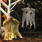 Halloween Hanging Ghost set in yellow and white, suspended on white tree with eerie netting and chains.