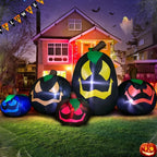 Halloween inflatable decoration of five glowing black pumpkins with colorful faces on front lawn