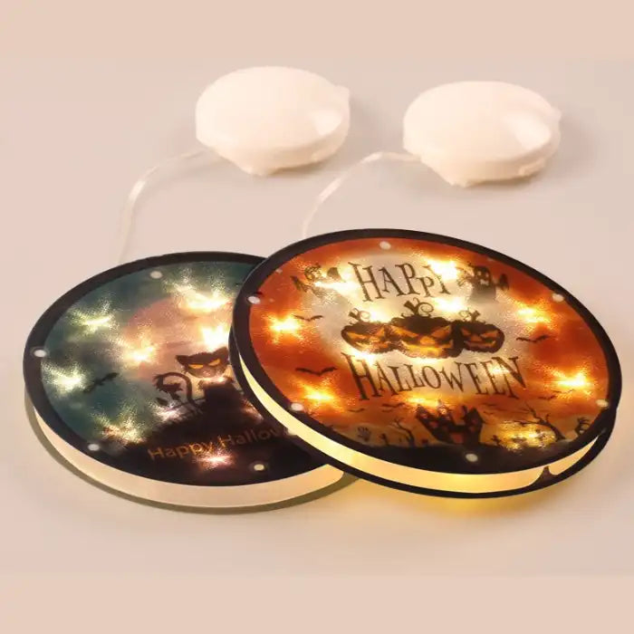 Halloween Lanterns with glowing lights shown flat on beige surface in tabletop product showcase.