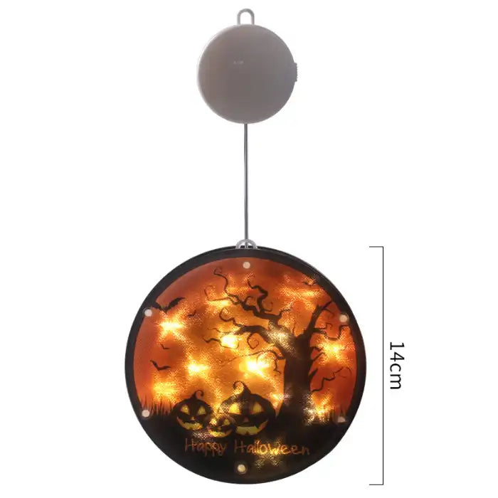 Halloween Lanterns with glowing pumpkins and spooky tree silhouette on orange-lit circular panel.