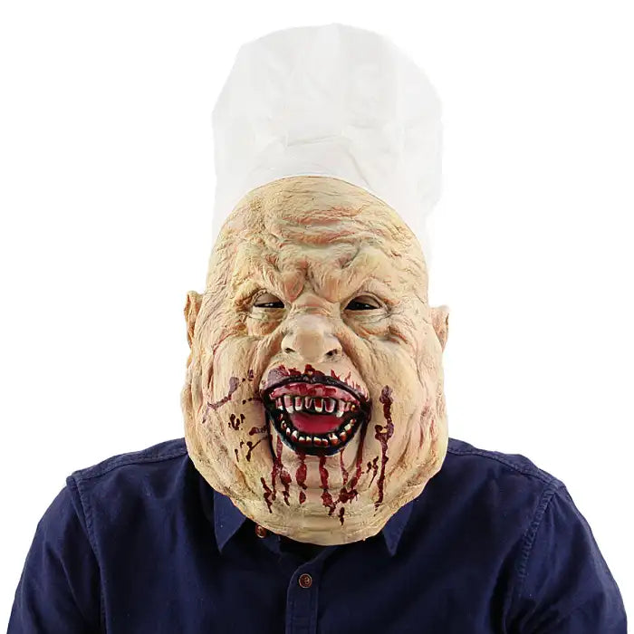 Halloween mask of grotesque bloody chef with wrinkled face, sharp teeth, and white chef hat.