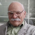 Halloween Mask showing old man with white mustache, bald head, and wearing glasses and gray jacket