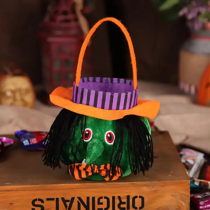Halloween pumpkin candy bag designed as green witch with striped hat and orange handle
