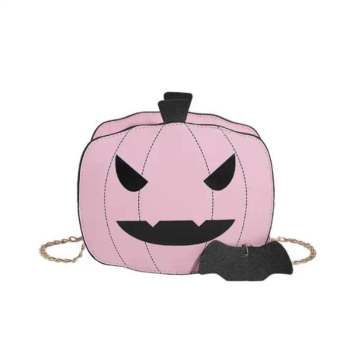 Front view of pink Halloween Pumpkin Head bag with black face and bat charm