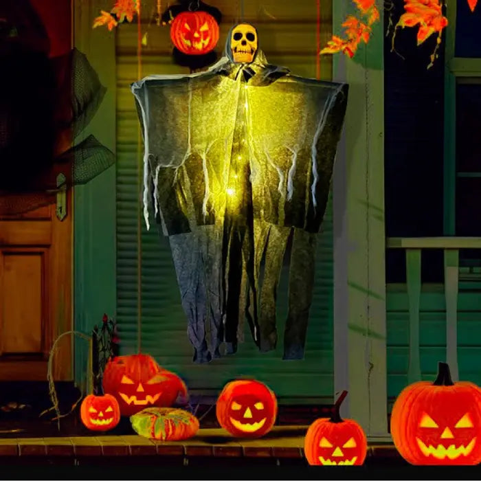 Halloween skeleton ghost hanging on porch with glowing jack-o'-lanterns and orange festive lighting.