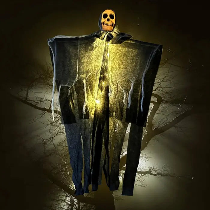 Halloween skeleton ghost glowing with yellow lights hanging in front of spooky tree under moonlight.
