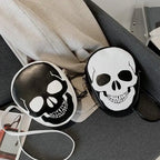 Two Halloween Skull Bags in black and white displayed together on a grey sofa with contrast straps.