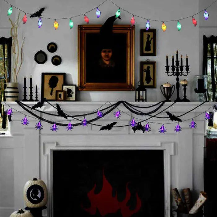 Halloween string lights with spiders, bats, and ghosts hanging above a decorated fireplace mantel