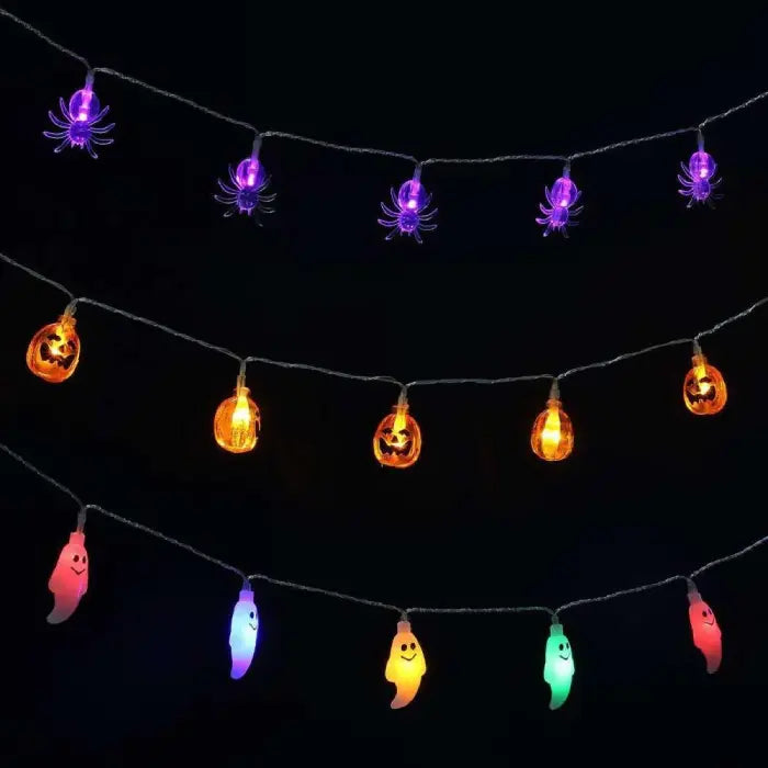 Halloween string lights with spider, pumpkin, and ghost designs hanging on a dark wall