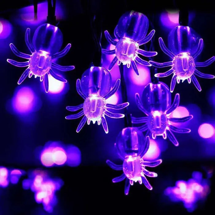 Halloween string lights featuring glowing purple spider bulbs on a dark background for spooky decorations