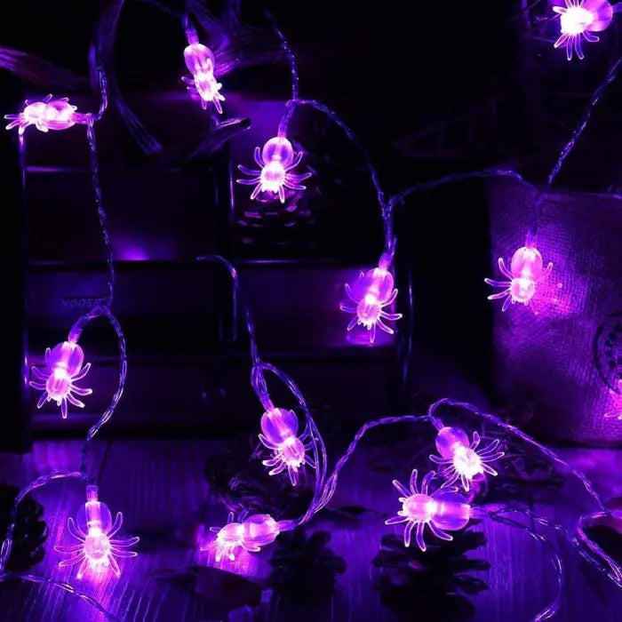 Halloween string lights with purple spider bulbs strung across indoor surfaces for festive ambiance