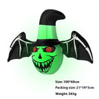 Halloween yard inflatables green witch face with bat wings and hat, perfect for night-time displays.
