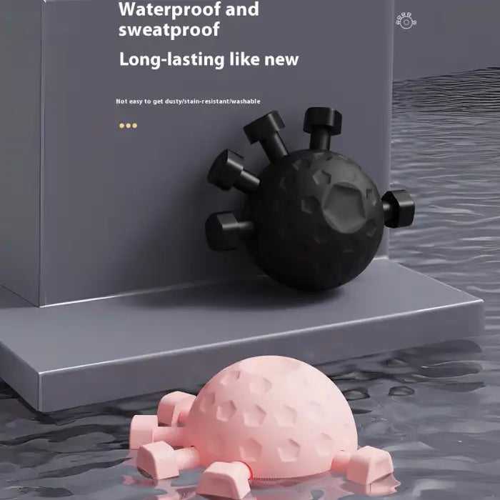  .Hand Strengthener waterproof and sweatproof black and pink balls shown in water-resistant environment