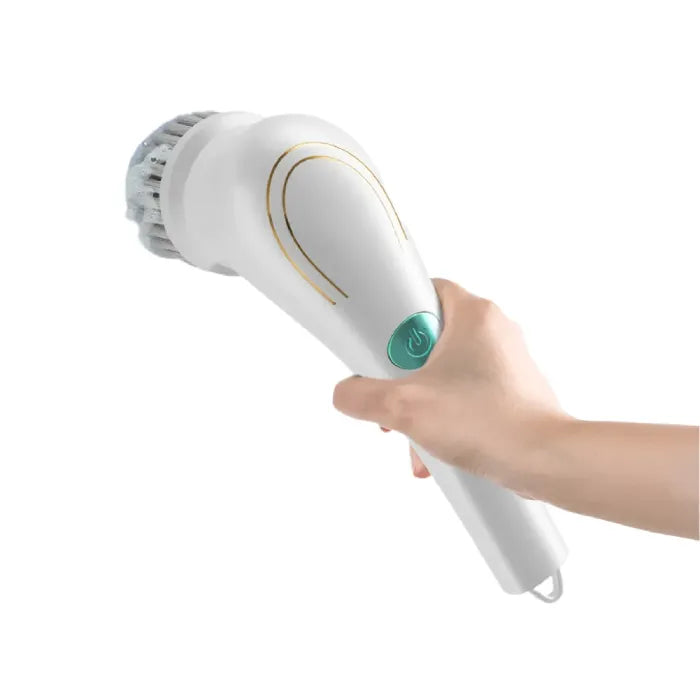 White electric facial cleansing brush with gold accents, bristle head, and turquoise power button held in hand