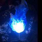 Handheld fireball prop with intense blue LED light, displayed on stand in low-light room.