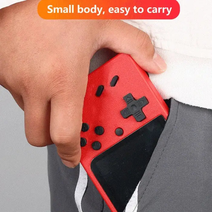 Hand holding red portable gaming console showing compact size and comfortable grip