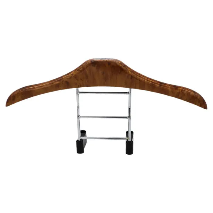 Wooden car clothes hanger securely attached to a vehicle headrest.