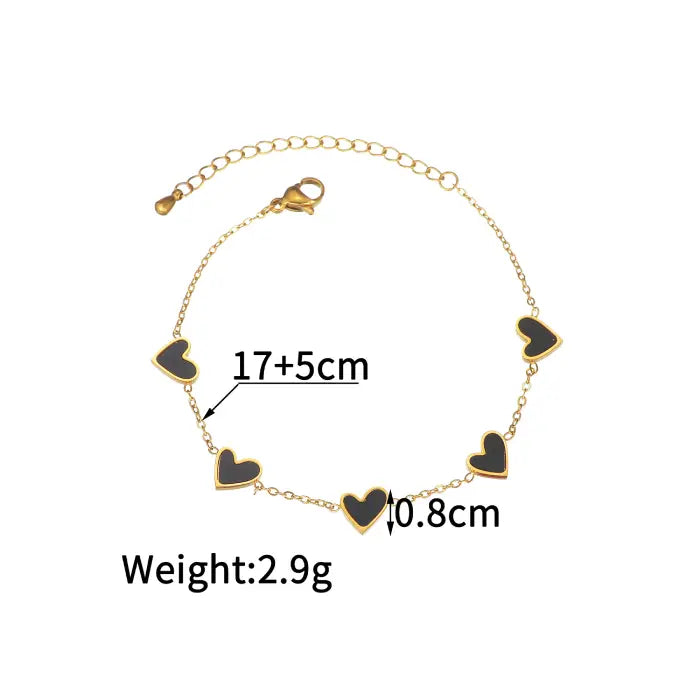 heart-charm-bracelet in gold with black hearts shown with size measurements for accurate fit, offering a sleek modern bracelet option