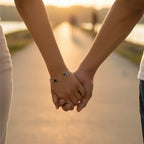 heart-charm-bracelet shown on couple holding hands at sunset with dainty hearts, creating a romantic vibe and inspiring gift ideas