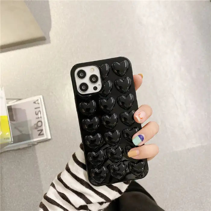 Heart iPhone case in glossy black silicone with 3D raised heart pattern for sleek sophisticated protection and improved grip