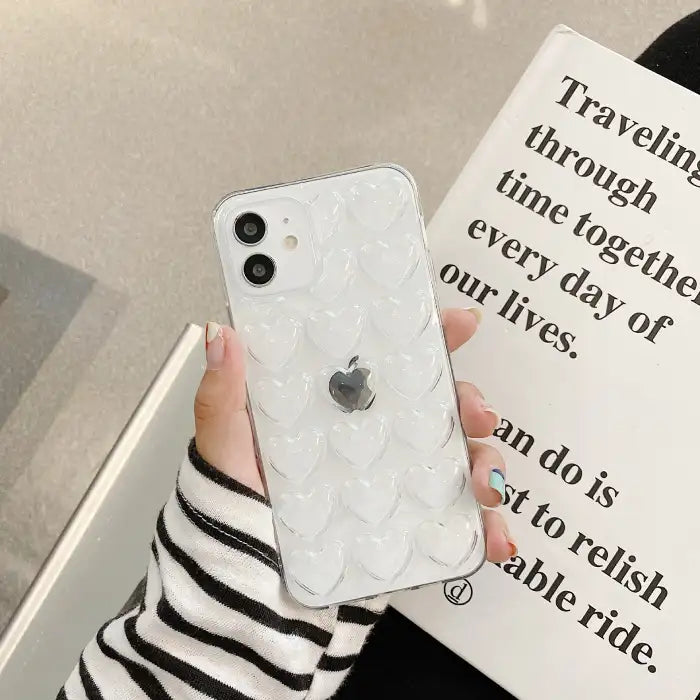 Heart iPhone case with transparent clear design featuring 3D raised hearts that showcase original device while providing protection