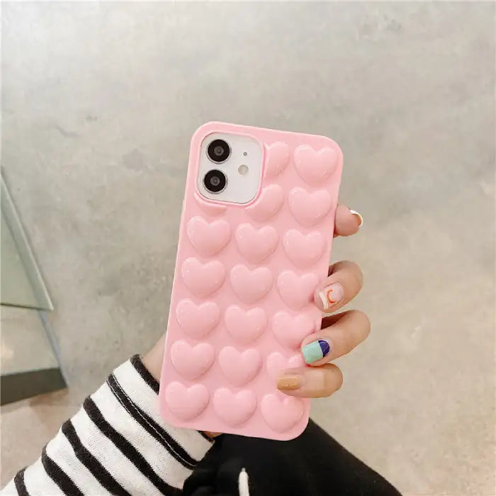 Heart iPhone case with soft pink 3D bubble heart pattern offering cushioned protection and feminine aesthetic design