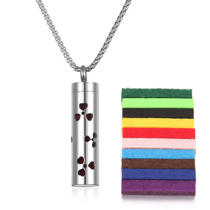 Heart pattern stainless steel aromatherapy pendant with colorful felt pads for essential oil use.