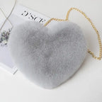 Grey heart shoulder bag in plush texture, ideal for cozy or winter fashion looks.