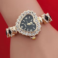 Heart stone watch with black dial and crystal border shown on wrist featuring black gemstone bracelet accents for elegant feminine styling
